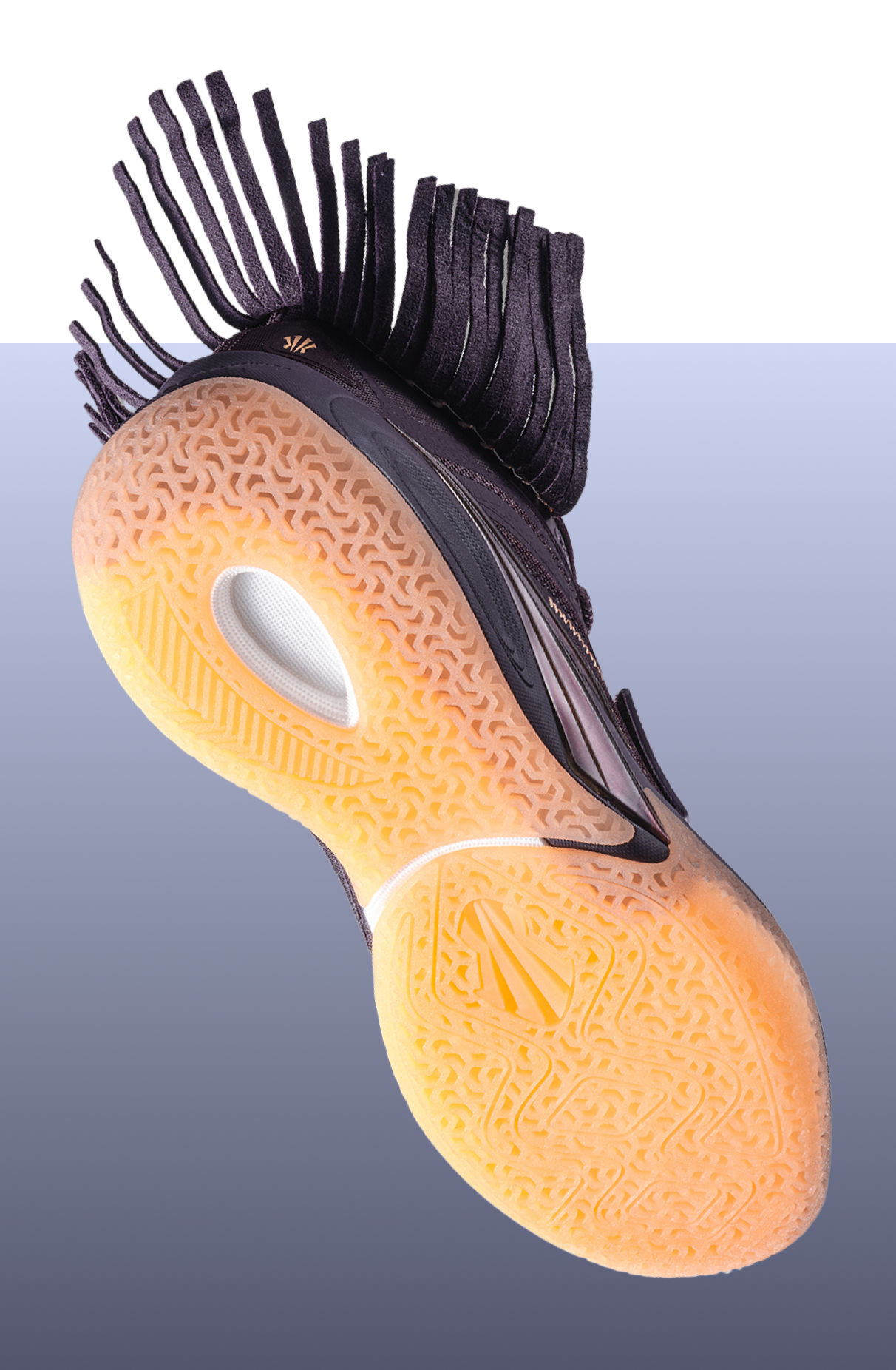 The earth-toned outsole features an organic texture that grounds the silhouette in both ritual and performance.