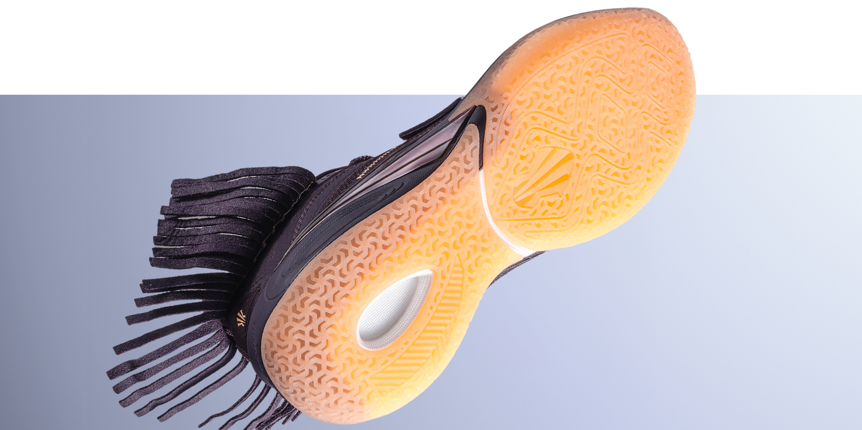 The earth-toned outsole features an organic texture that grounds the silhouette in both ritual and performance.